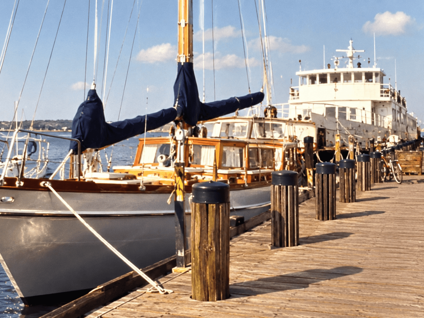 Archival photograph of the Nantucket Steamship Authority ferry wharf circa 1978, showing a ferry, wooden dock, and other boats moored nearby.