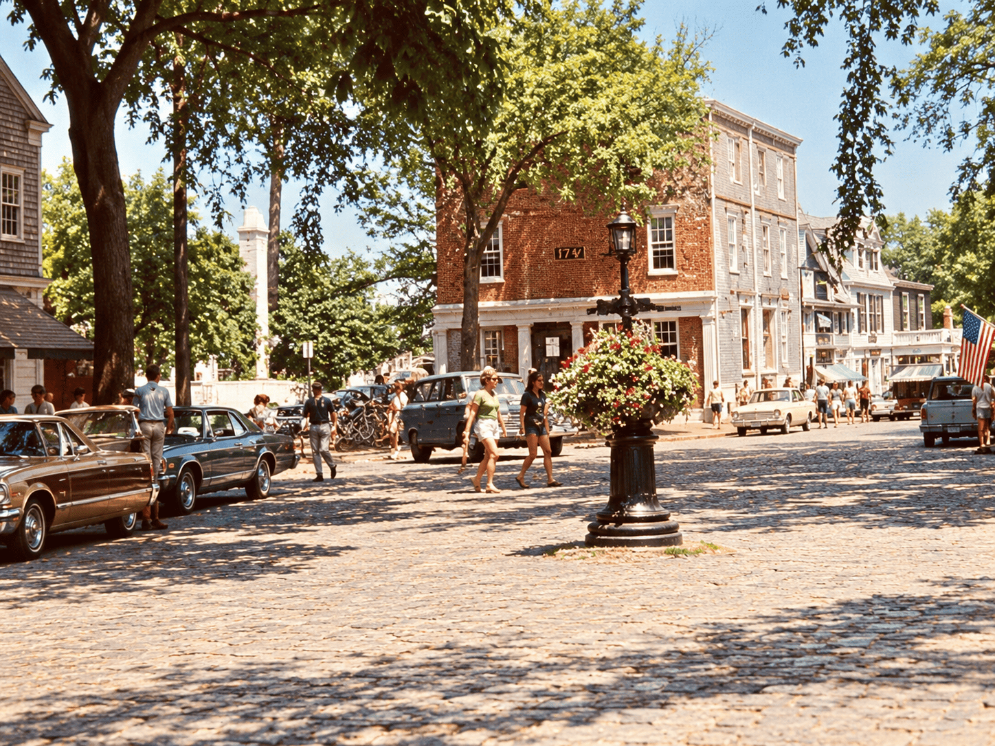 Historic 1978 photograph of Main Street in Nantucket, Massachusetts, showing the central urn, parked 1970s automobiles, and surrounding buildings.